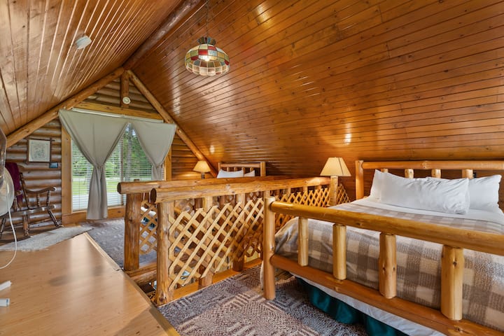 The loft space in the main cabin. It has two full size beds. Note: this space has pull down black out curtains but it is an open space.