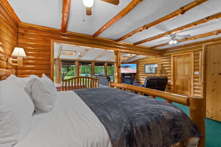 This is the main bedroom in the main cabin. It has a king bed and a private bathroom. The hot tub is located in the main bedroom.