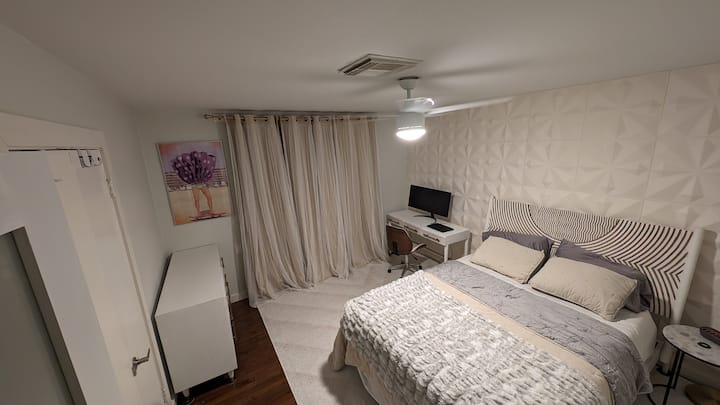 Indulge in modern luxury at our Airbnb bedroom 1. Featuring Anthropologie's chic furniture, enjoy a cozy bed, elegant dresser, and a practical computer table – the perfect blend of style and comfort awaits you.