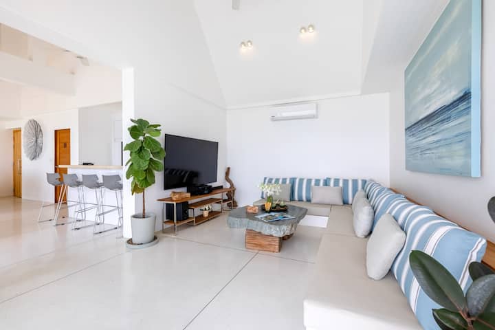 Გარედან შესვლა აჩვენებს მარტივ L-ფორმის დივანს, რომელიც ადვილად იტევს 6-8 ადამიანს. Მასში არის ტელევიზორი, საკაბელო და ინტერნეტი, ასევე, სამზარეულოსა და სასადილო სივრცეებს.