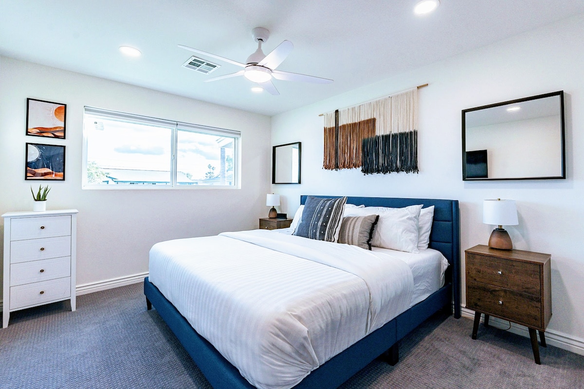 Bedroom 3 — bright king with plush bedding and smart tv