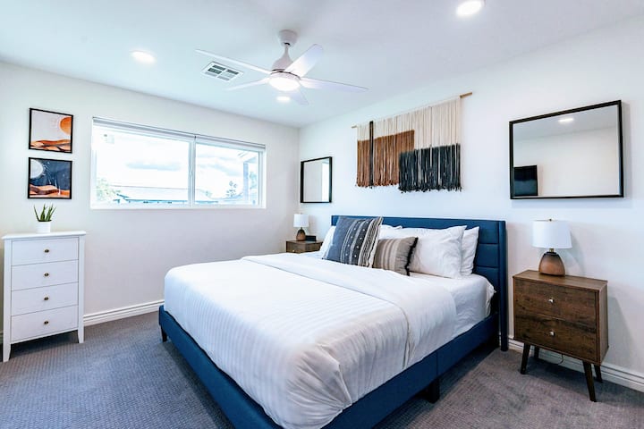 Bedroom 3 — bright king with plush bedding and smart tv
