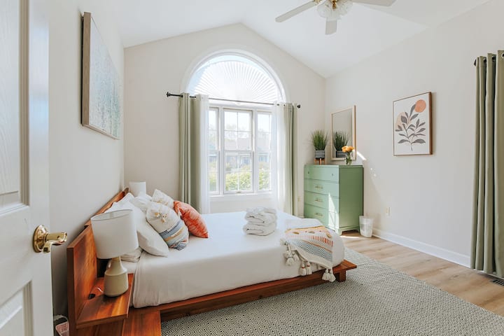 This light-filled room includes a queen-sized bed with memory foam mattress on a European-style low platform base