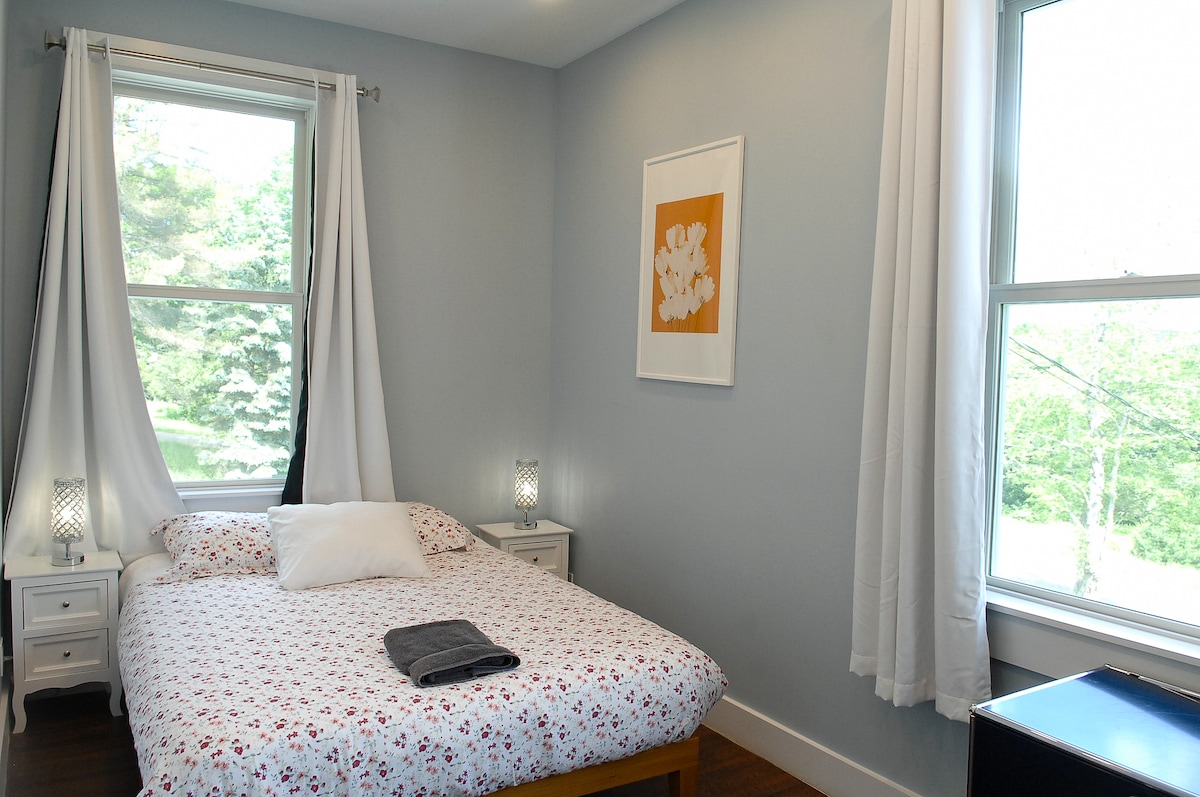 Bedroom 2 has a queen sized bed.  The large windows have light locking curtains for late sleepers.