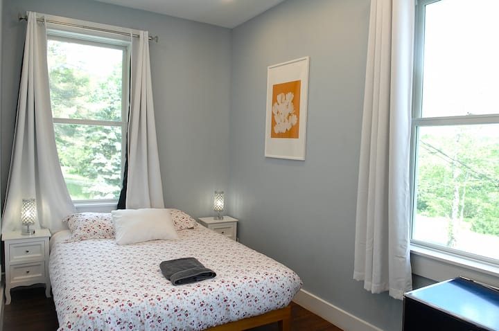 Bedroom 2 has a queen sized bed.  The large windows have light locking curtains for late sleepers.