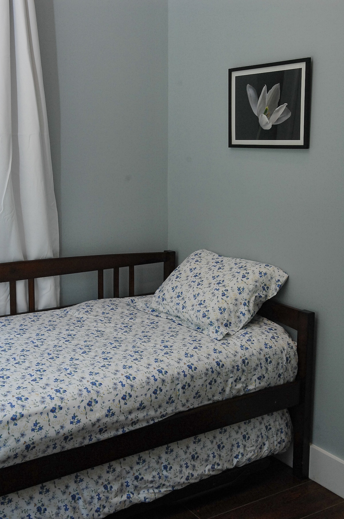 Bedroom #3, the first-floor bedroom, equipped with a twin bed and a trundle, is wheelchair accessible. It is adjacent to a full bathroom featuring a walk-in shower and safety grab bars.