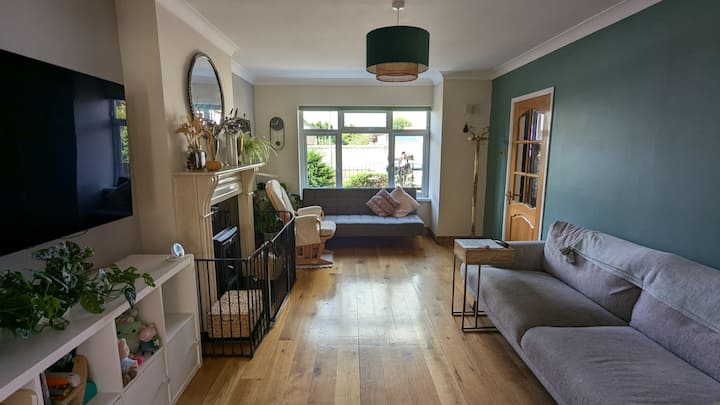 Un vestíbulo con una chimenea que se abre al comedor, con el telón de fondo de una puerta de patio francés.