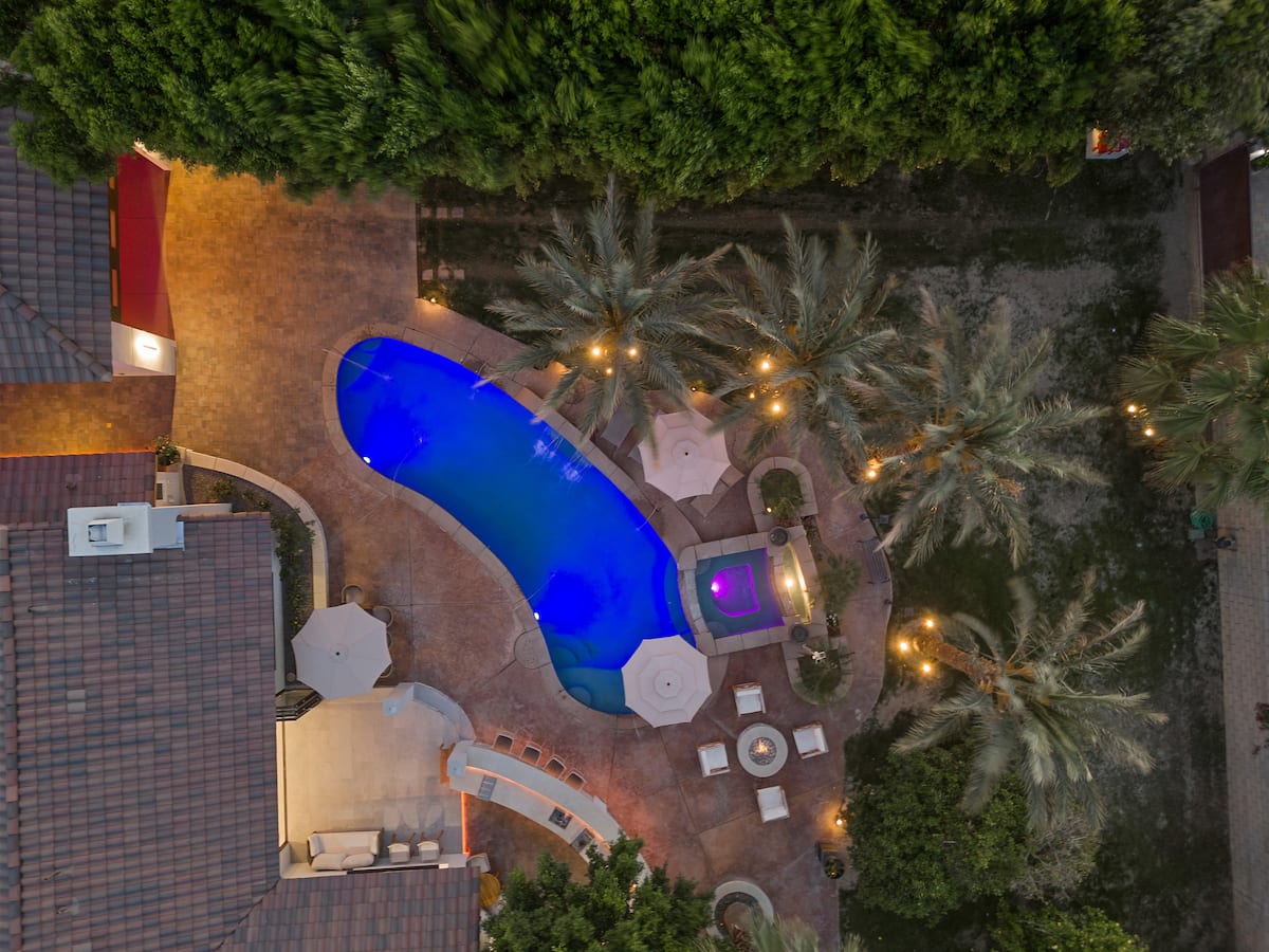 The pool lit blue at night, seen from above