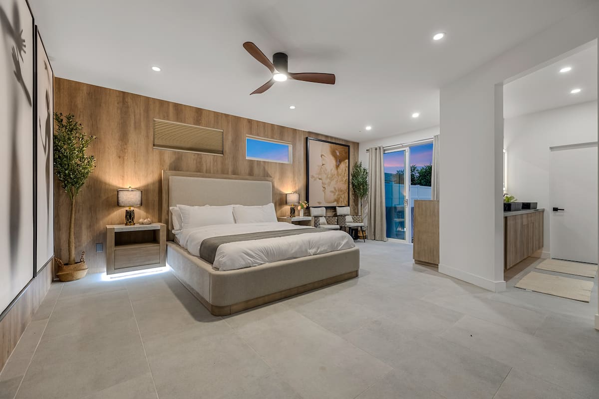Primary suite with king bed and direct pool access