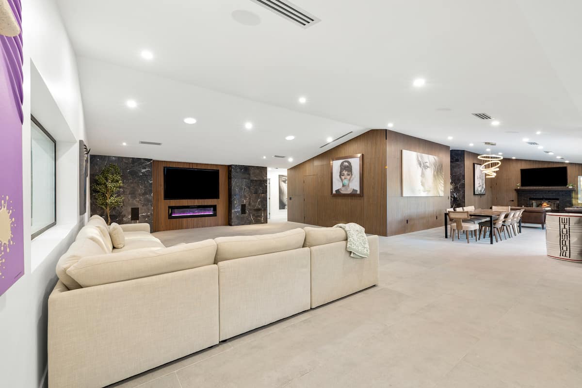 Open living room with sectional seating and a linear fireplace