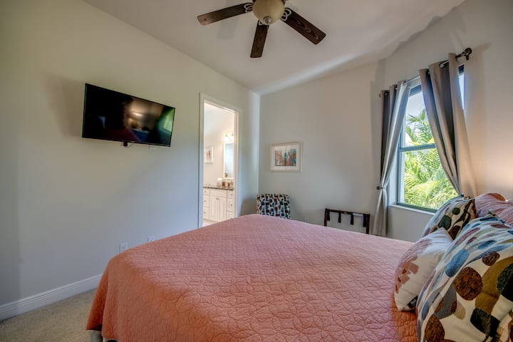a 32" flat-screen TV (ROKU) and a private bathroom with walk-in shower.