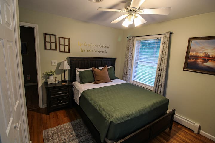 Bedroom with queen sized bed on main level of the house.