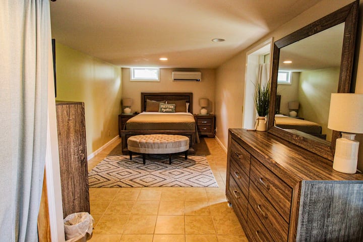 Second bedroom on the lowest floor of the home.  Queen sized bed with a door that exits to the deck with the hot tub.
