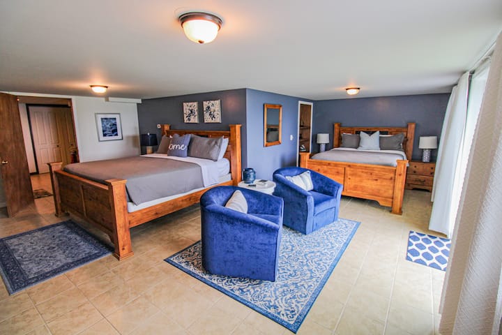 Bedroom on the lower level of the home.  Has a king sized bed as well as a queen.  Sliding glass doors exit into the backyard.