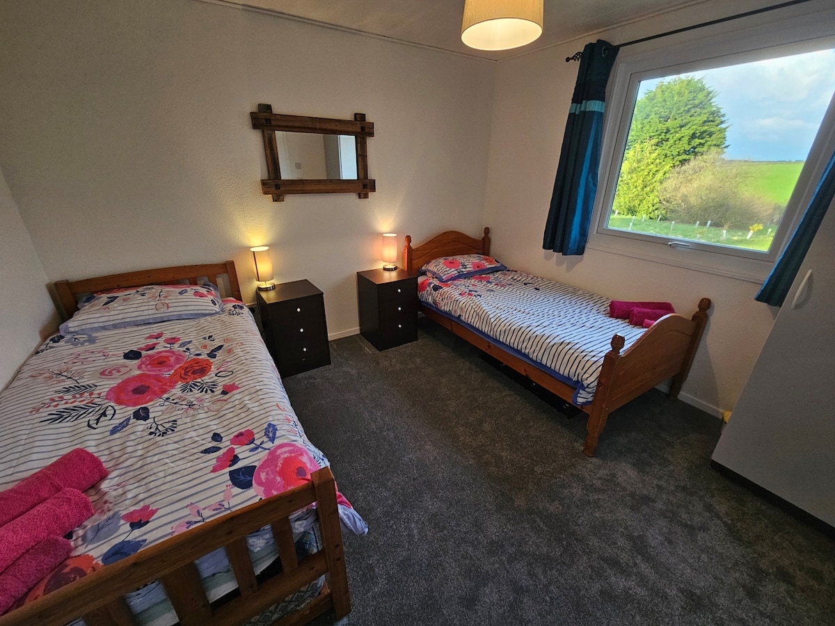 Our second bedroom, features two single beds, two nightstands, and one wardrobe for use. Another wardrobe has spare bedding/pillows for your use and some boardgames etc