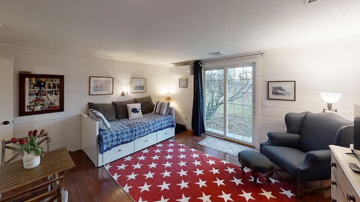 Sitting room/front entrance. Couch is a trundle that pulls out to queen sized mattress