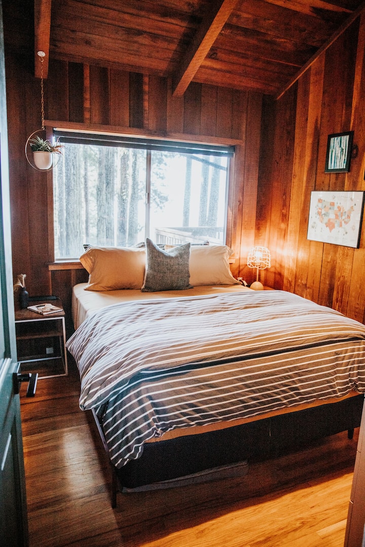 Bedroom 1 features a plush memory foam queen bed with ocean views. Adorned with adorable and snug linens, you may find it hard to ever get out of bed. Charging your your technology at night is a breeze with our bedside chargers. 