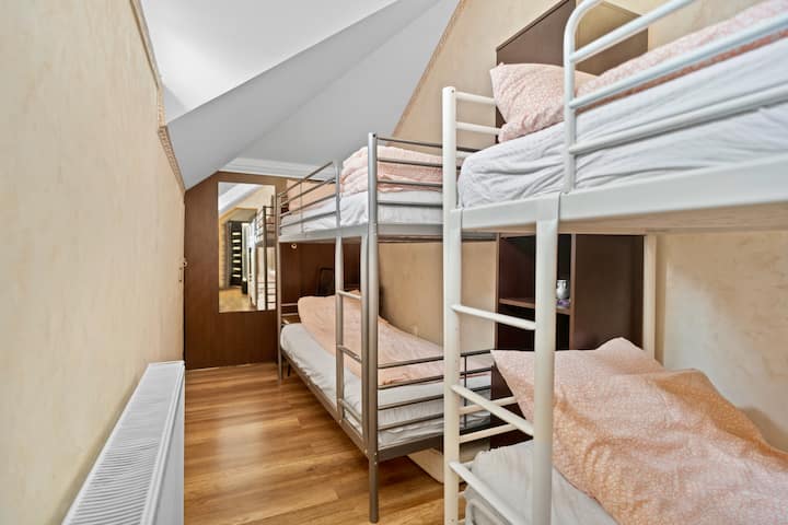 This room offers practical comfort with two sets of bunk beds, providing ample sleeping space for up to four guests, making it a great choice for groups or families.