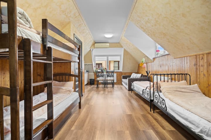 This fun, functional room sleeps 4 with bunk and single beds, plus a sofa and dining area for groups or families.