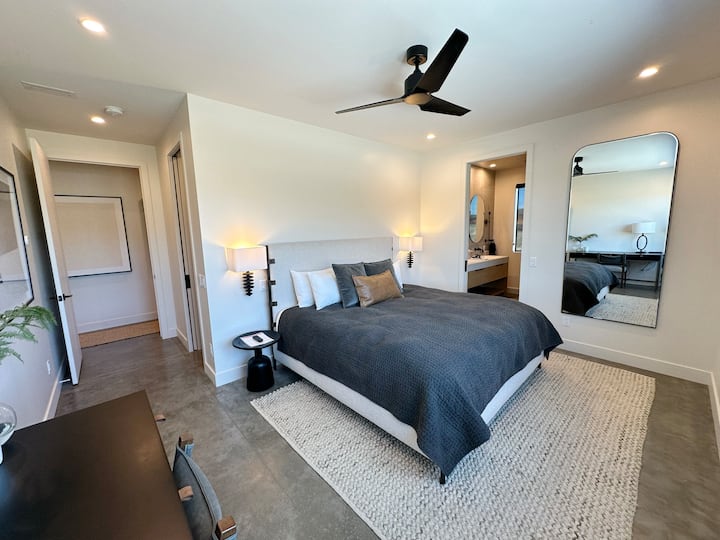 Walk in closet located inside bedroom. Reading sconces on both sides of king bed. Ensuite bathroom with pocket door. Bedroom has its own Thermostat for your specific radiant heat.
