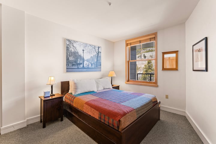 The bedroom has a queen-sized bed and offers mountain views.