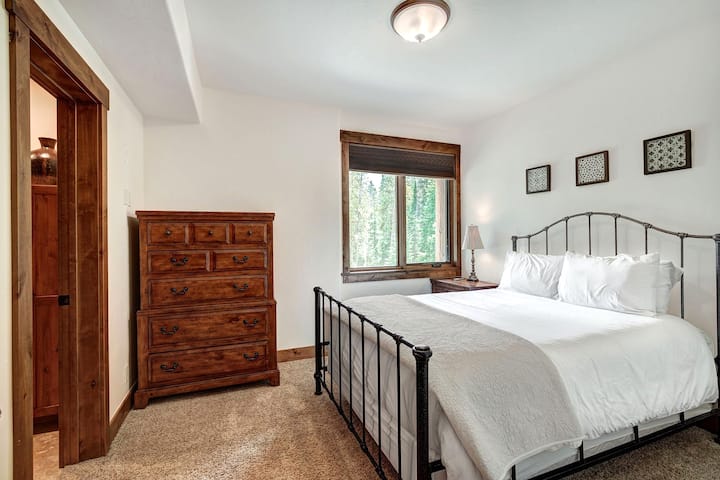 Bedroom with queen sized bed, dresser and en-suite bathroom.
