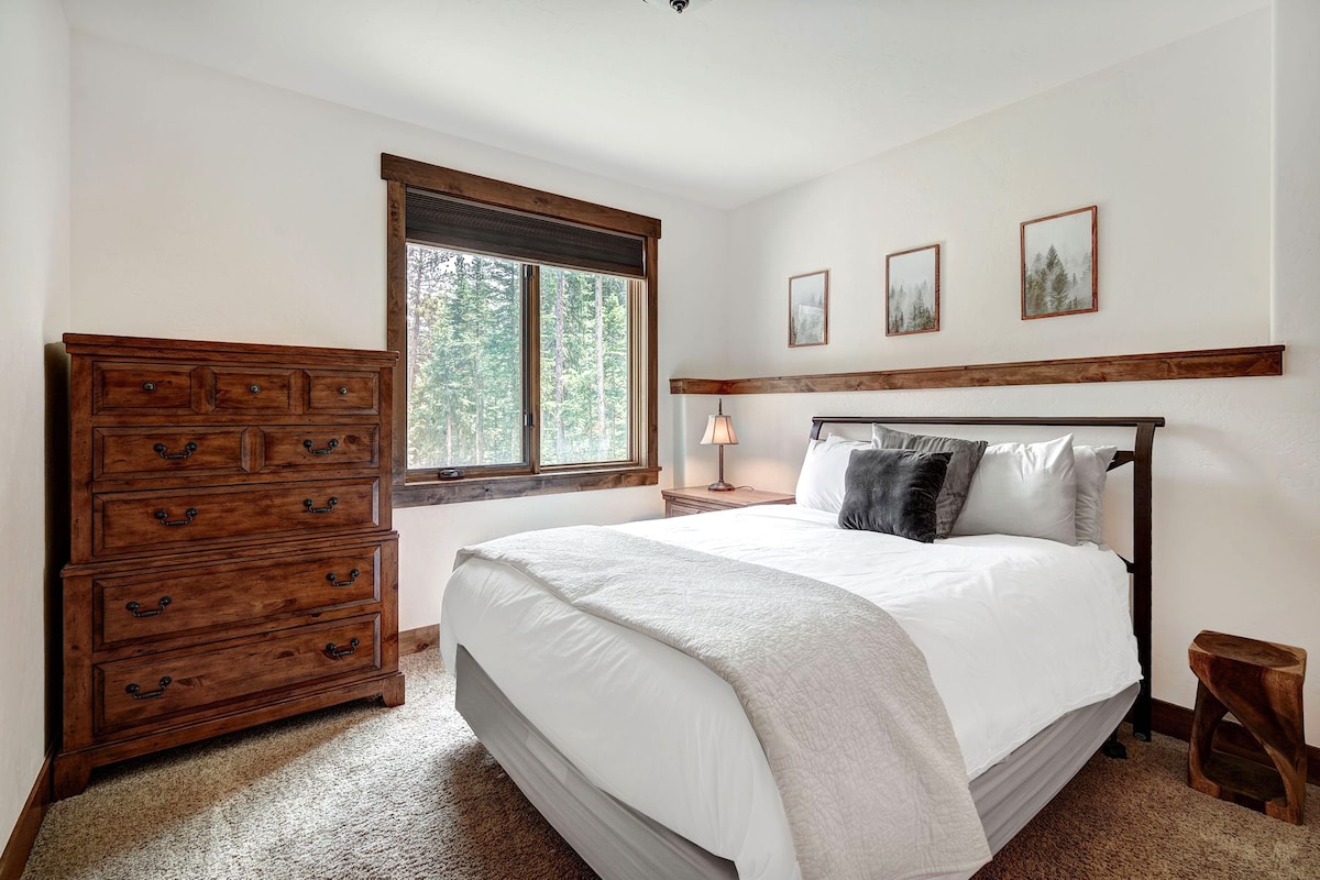 Downstairs bedroom with queen bed, dresser and large closet.