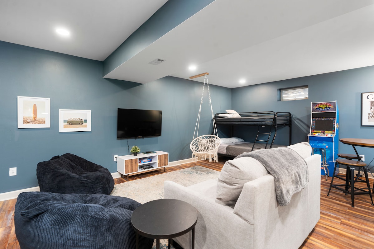 Basement game room featuring 2 bunk beds and arcade