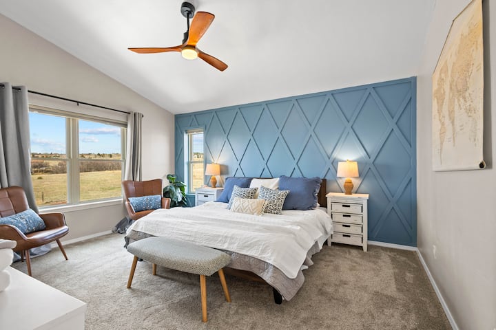 Upstairs master bedroom with King bed, sitting area, TV, and En suite full bathroom with walk in closet.