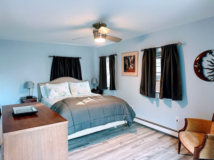 all the way in the back on the ground floor.  Full bathroom is off the back of the bedroom.  Folks have put the dog crate in the room and/or a pack and play.  Sliding glass door to the fenced backyard is also from this bedroom.