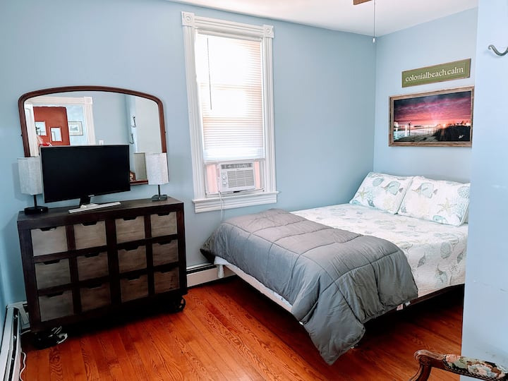 Front bedroom off front living room/front door. Queen bed. An extra 28" monitor is available.  HDMI cable and a dongle can help you connect your computer/device.