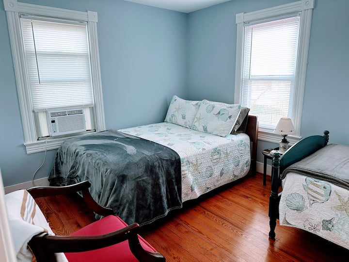 Top of the stairs, first bedroom on the right has a full bed, and a twin bed.  and, enough room for a pack and plan (or 2). Yes you can see the water from the front windows