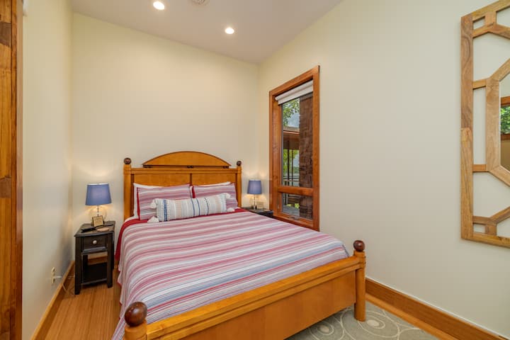 Bedroom on main level with queen bed, smart tv and views of the lake