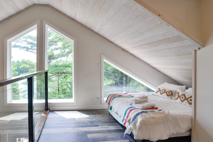 Queen sized bed located in the open loft. There are no doors and it is open directly to the great room downstairs. It has low headspace but absolutely stunning views. 2nd bathroom is located in the loft as well.  
