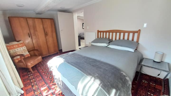 غرفة نوم مشمسة واسعة مع سرير بحجم كوين مريح للغاية