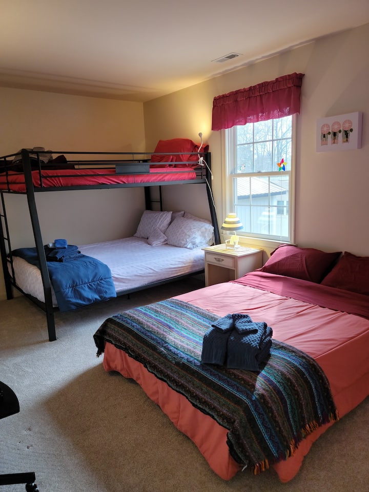 Chambre colorée et confortable avec lit superposé entièrement queen size, lit double supplémentaire, tout en vue de la télévision pour regarder des films ! Les lampes comprennent une veilleuse aux flamants roses au néon.