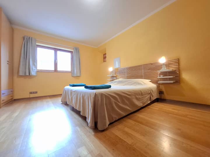Bedroom 3 on the ground floor with a double bed, single bed, AC, wardrobe, bedside tables, drawers, desk and chair