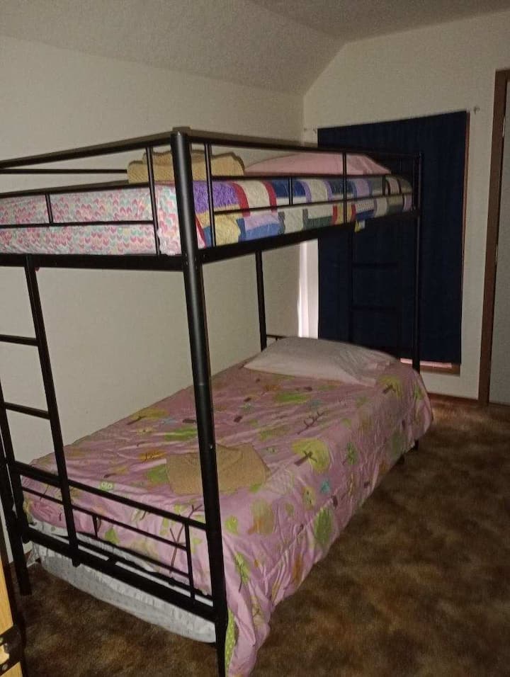Double bunk bed plus bonus pull out trundle. Other side of room has a chair and desk for "remote office" as needed.