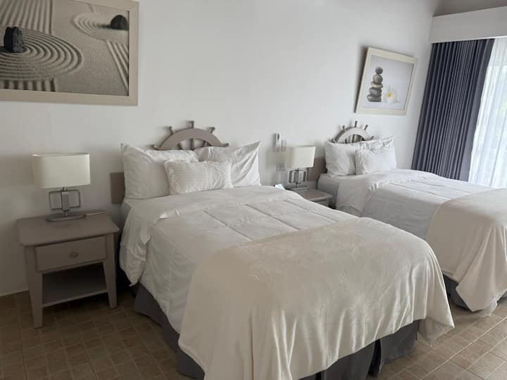 Our cool and cozy room is the perfect place to relax and unwind, with comfortable full double beds and light decor, this room offers a quiet and serene atmosphere