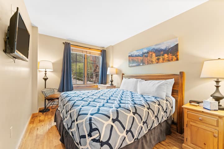 Primary bedroom with attached bathroom for privacy and easy access. TV has been replaced with larger TV in 2025.