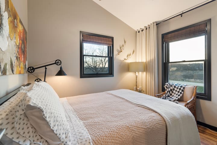 2nd bedroom is cozy, has a reading chair and a 36" wall mounted TV.