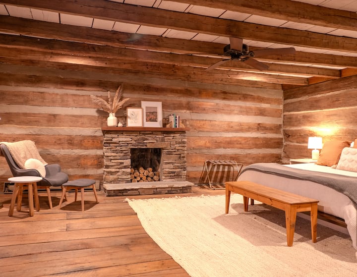 Experience tranquility in our master bedroom with stone accents and a decorative fireplace.