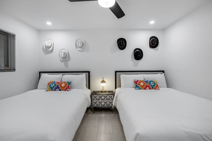 The Cowboy Room: Features two queen sized beds, Smart TV, and full length mirror. 