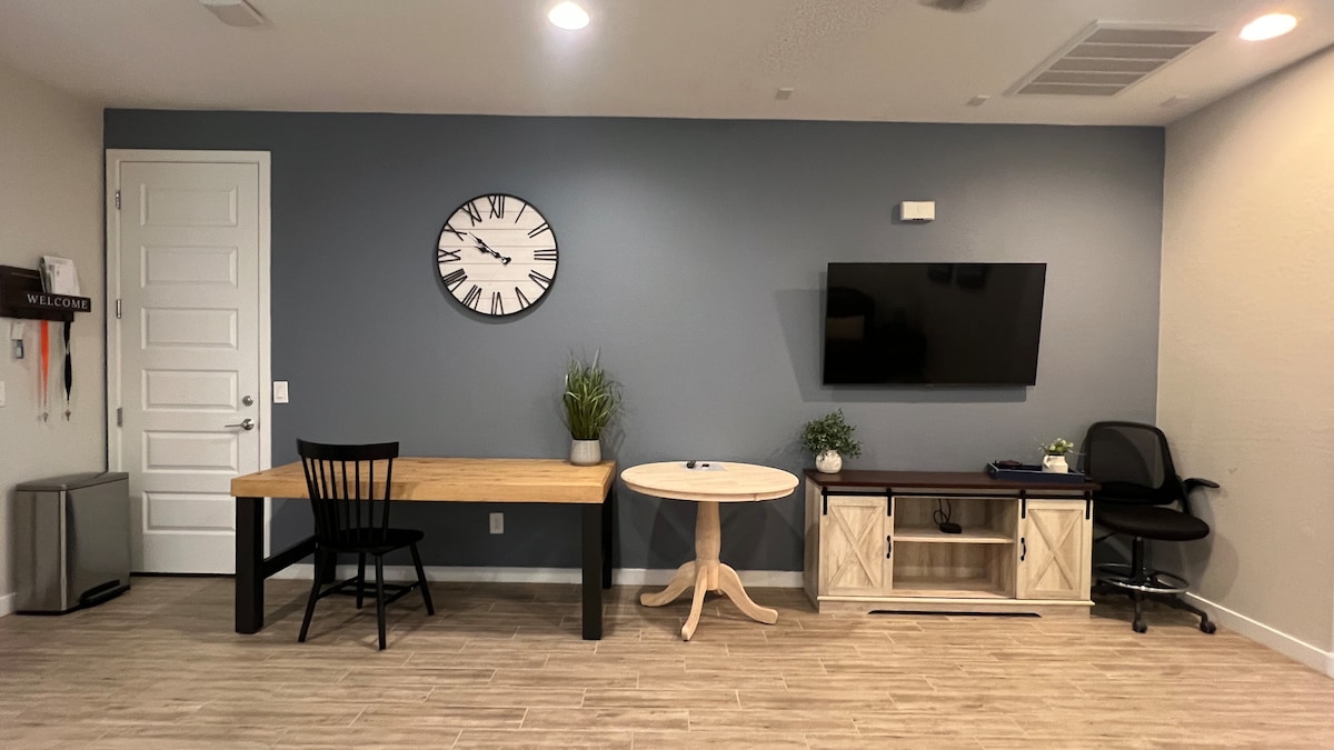 Multi-purpose room with workspace, TV, and seating—perfect for remote work, study, or relaxing after a long day.
