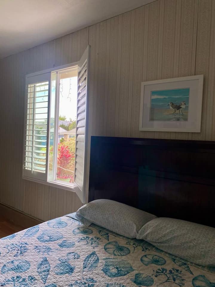 Queen size bed with sturdy wood headboard.