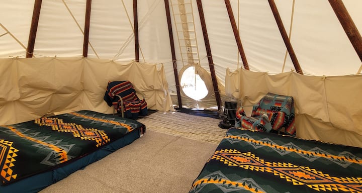 The tipi has two queen beds for a peaceful night's sleep. 
