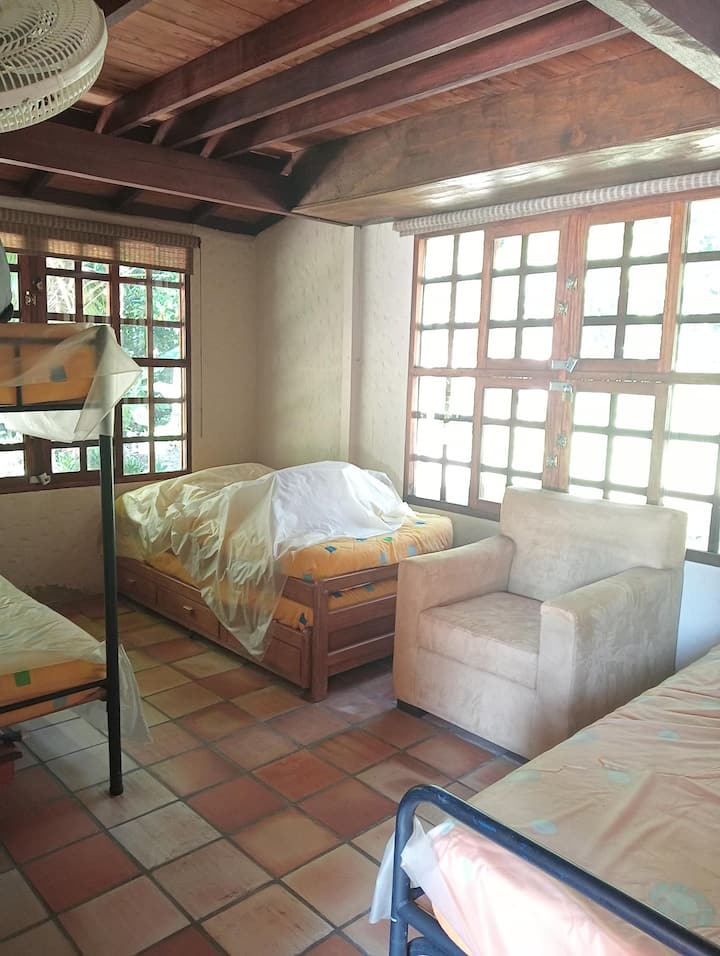 Chumba cha Ghorofa ya Kwanza kilicho na Nyumba 1 ya Mbao, Vitanda 2 vya Mtu Mmoja na Kitanda 1 cha Ghorofa kinachotoka chini ya Kitanda.
Nafasi ya watu wasiopungua 5.