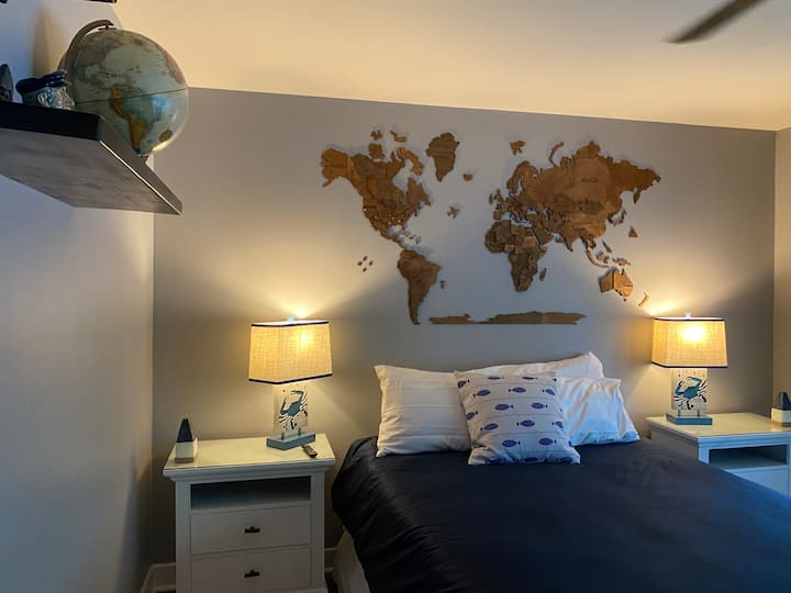 The Magellan is a large bedroom with a queen bed, dresser, closet and a ceiling pull-down television. 