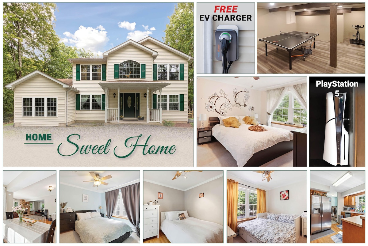 The exterior of the house features a modern design with large windows and a welcoming entrance. A spacious driveway accommodates multiple vehicles. A sign reading 'Home Sweet Home' is positioned prominently, accentuating the inviting atmosphere of the residence.