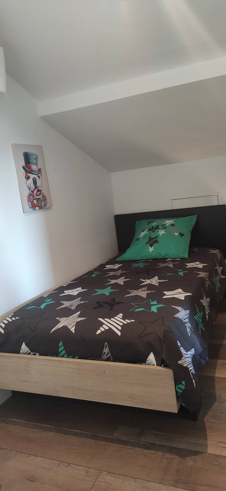 lit 90/200.  1 place 
en prolongement du bureau en mezzanine, proche à la chambre parentale 
l'ensemble étant entièrement climatisé.
séparation entre espace chambre (1 lit une place) et chambre parentale par un rideau occultant.